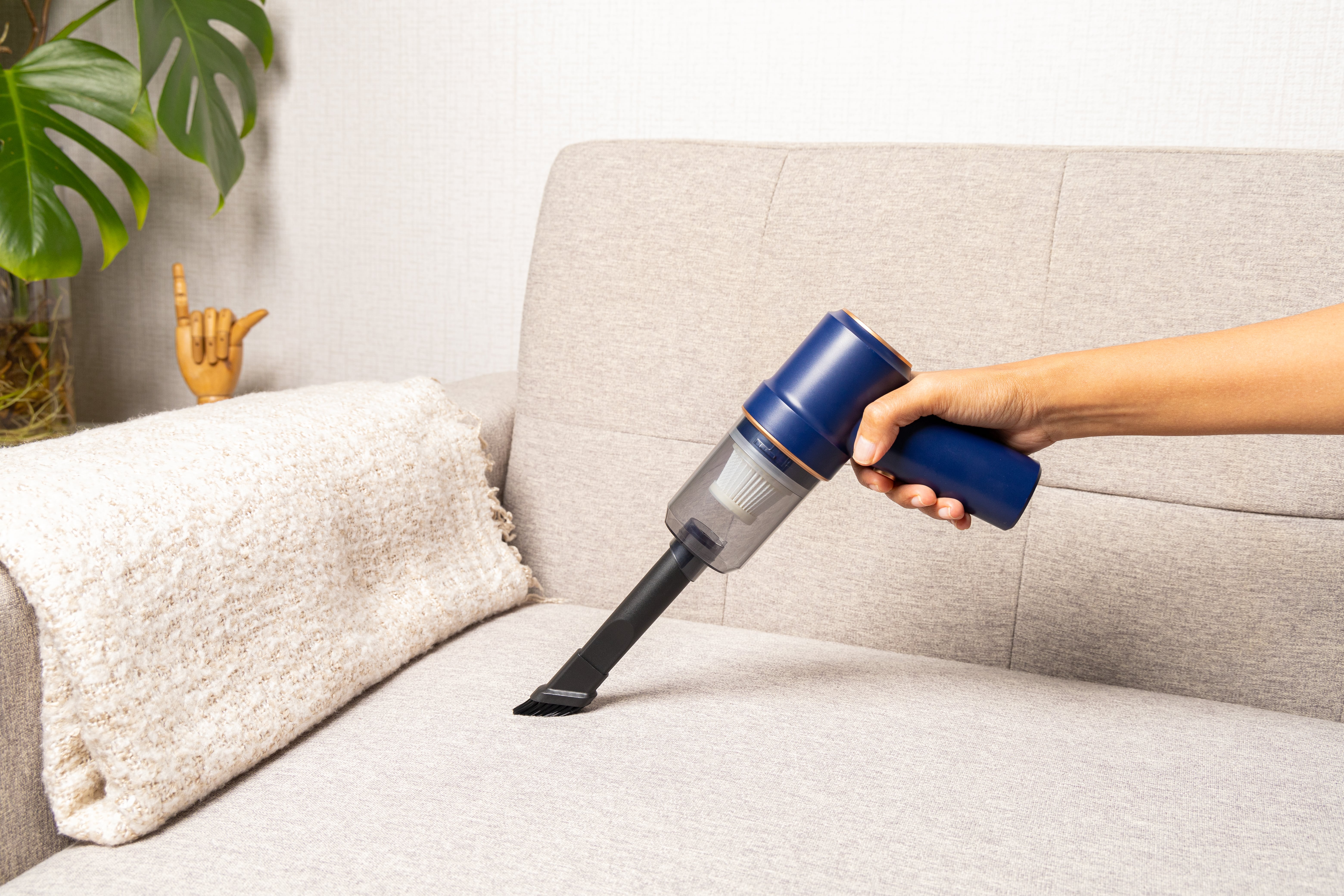 Mini desk vacuum cleaning up crumbs on a desk